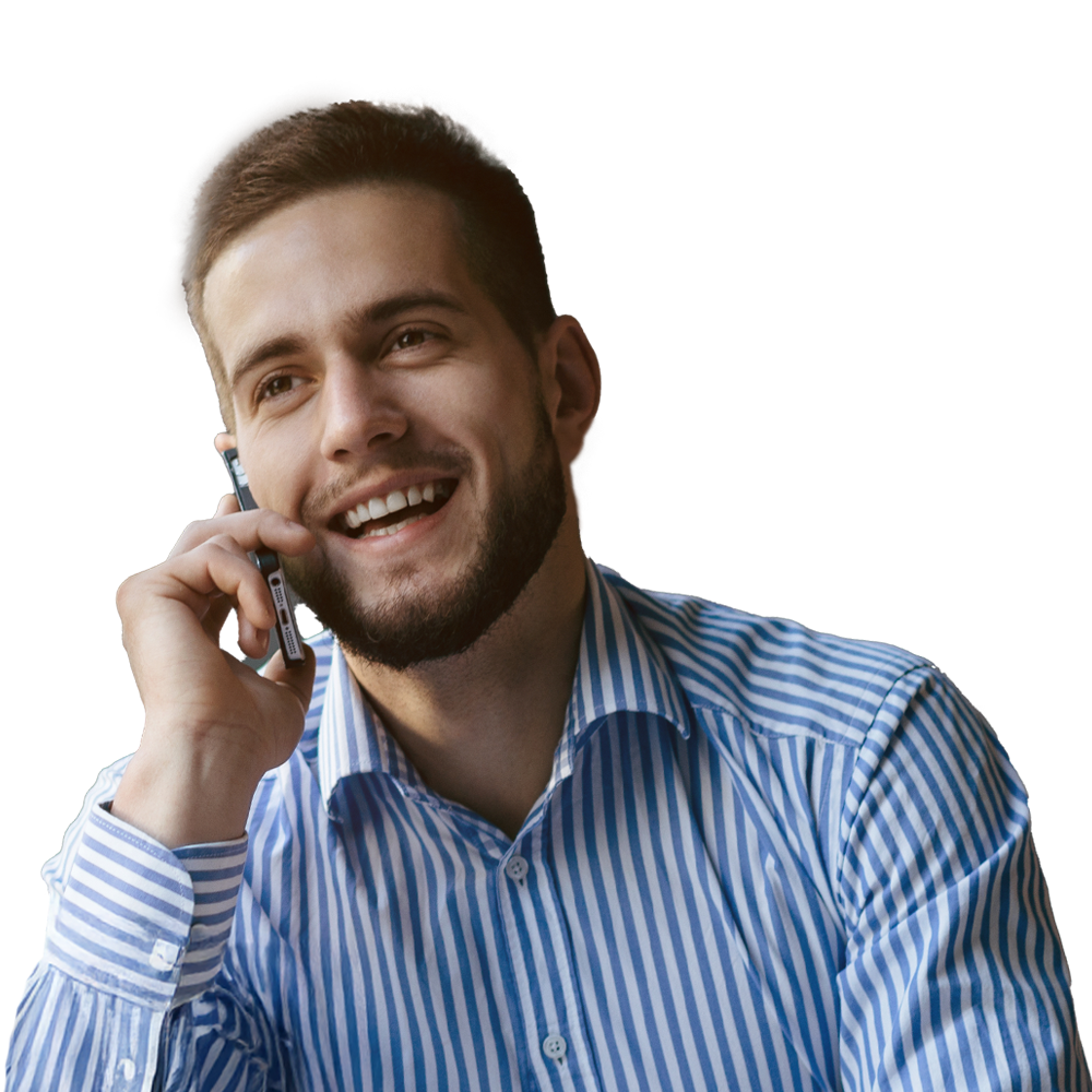 Man in a stripy shit on the phone smiling